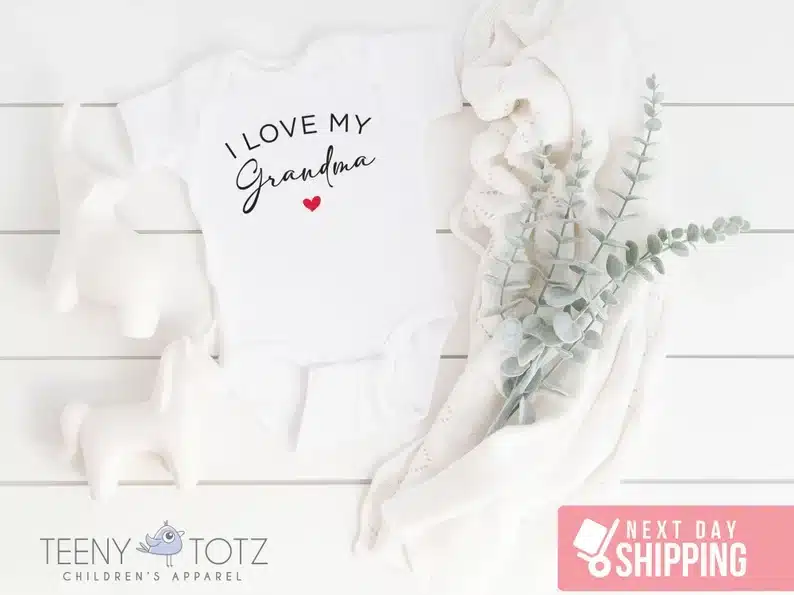 Mother's Day Gift Ideas for Grandma From Baby: white onesie with black font that says I love my grandma with a red heart below. 