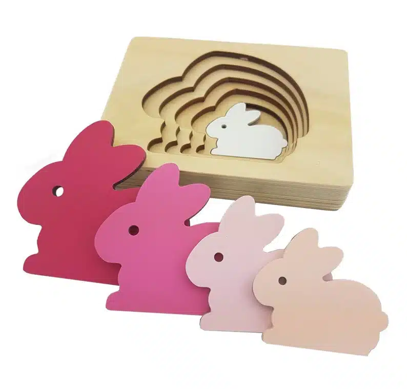 Easter bunny wooden puzzle with different shades of pink bunnies. 
