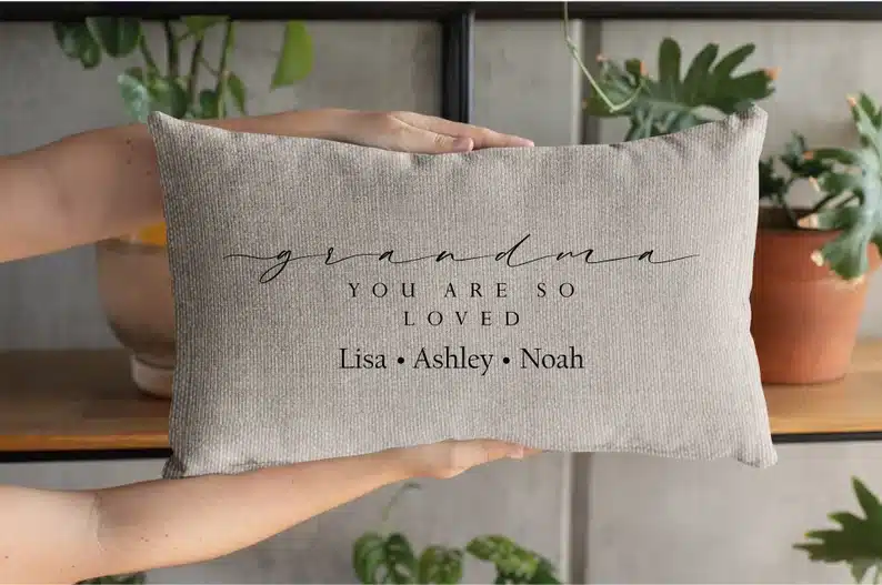 Grandparents’ Day Gift Ideas for Grandmas: Rectangle light grey pillow that says Grandma you are so loved, Lisa - Ashley- Noah. 