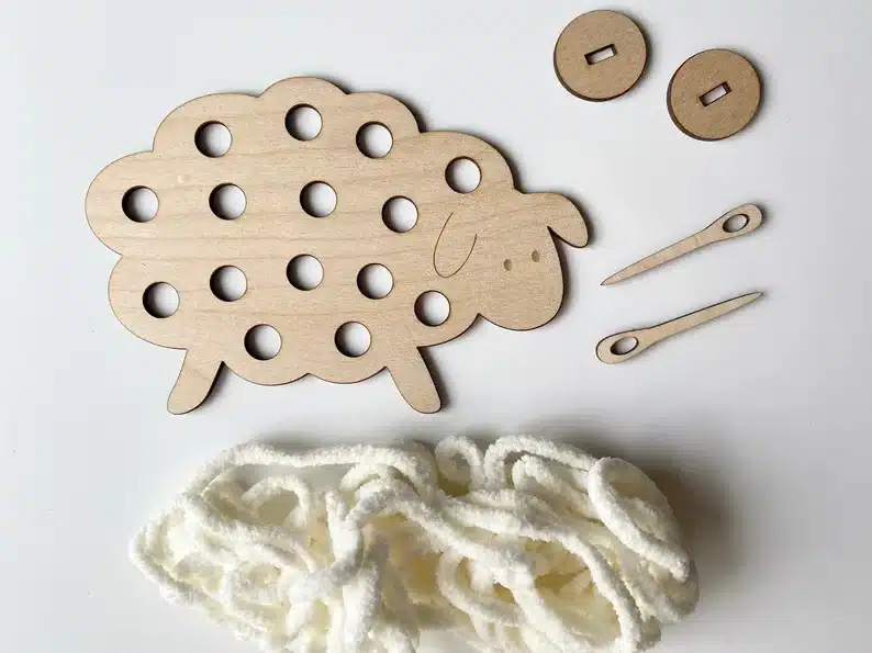 Easter Gifts for Kindergarten: Wooden sheet with holes on the back and yarn below with two wooden needles. 