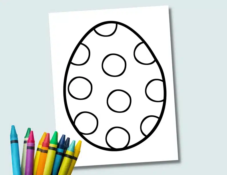 White paper with a coloring page of an Easter egg with dots, and many different colored crayons below. 