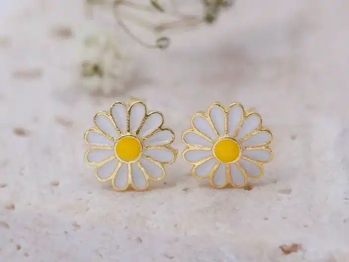 White Daisy stud earrings with yellow centers and gold trim all around. 