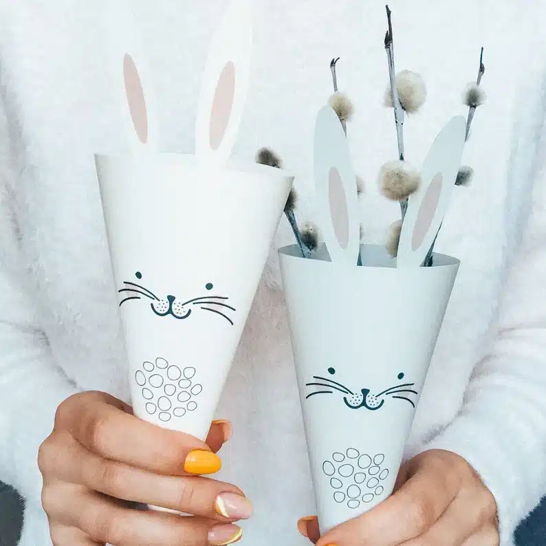 Two paper bunny cones, one with pussy willow in it. 
