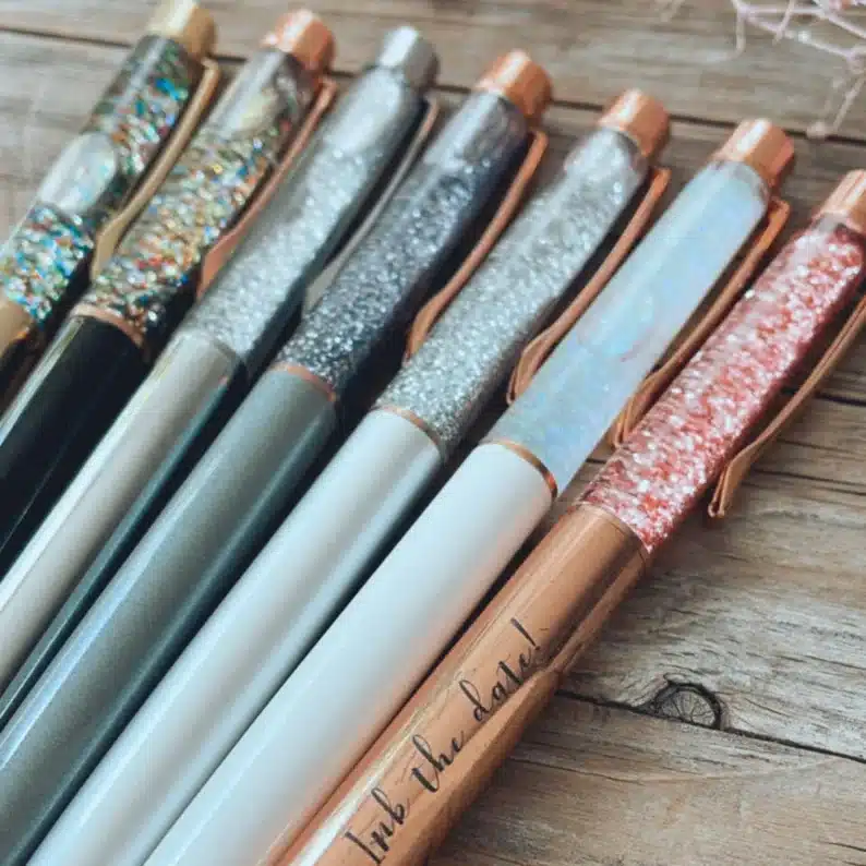 Administrative Assistant Day Gifts Under $10: Seven floating glitter pens shown. 
