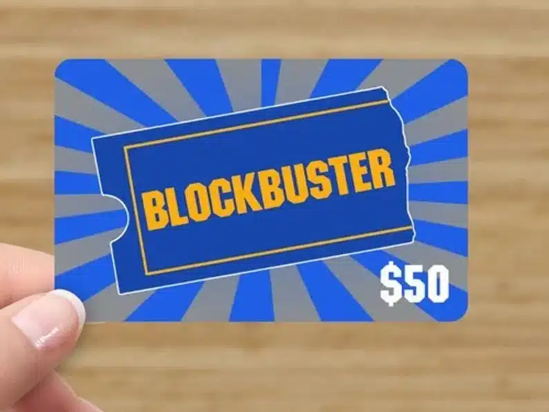 Womans hand holding a blockbuster $50 dollar joke gift card. 