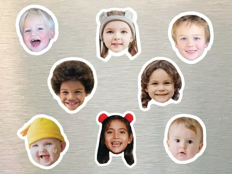Silver background with various kid faces as magnets on it. 