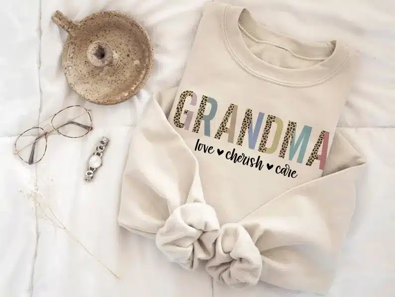 Tan long sleeve sweater that says Grandma, love - cherish- care. 