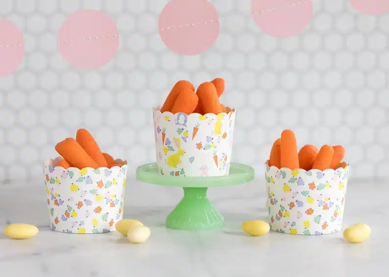 Three bunny snack cups all with bunny prints on them, carrots inside all of them. 