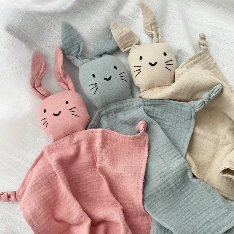 Easter Gifts for Toddlers: Three handmade bunny lovey, one pink, blue, and tan in color. 