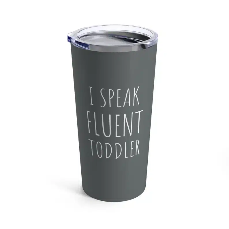 Travel dark grey coffee mug that says I speak fluent toddler in white font on it. 