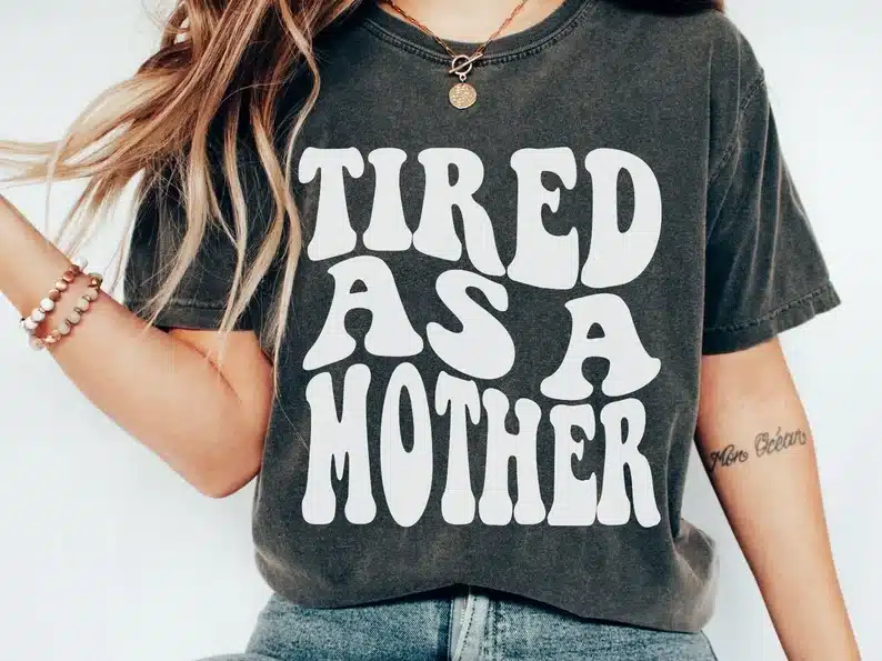Mother’s Day Gifts for a Daughter: Dark grey t-shirt with white font that says "tired as a mother"