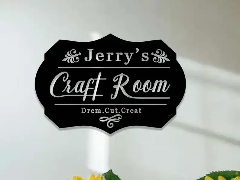 Black sign with white font that says Jerry's craft room. 