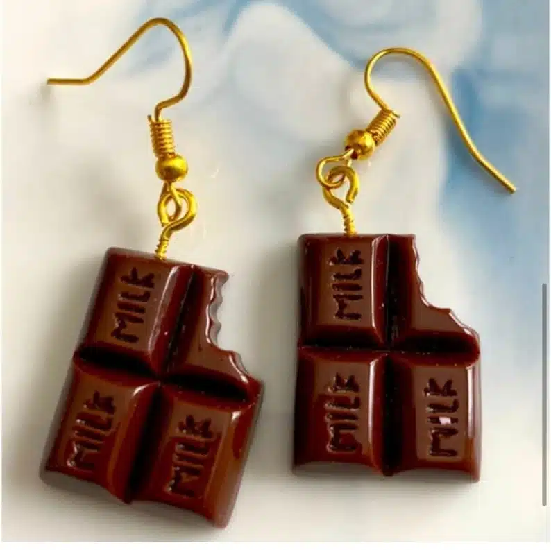 gold earrings with fake little four piece chocolate bar with a bite taken out of both. 