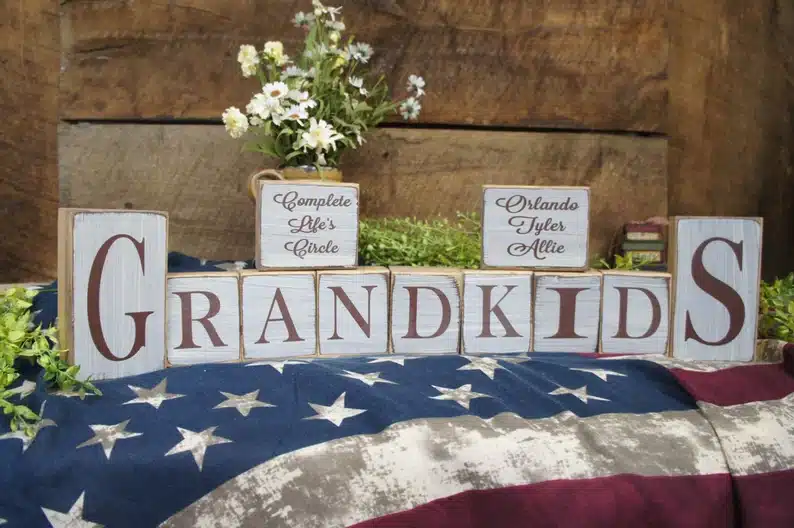 American flag with wooden blocks that spell Grandkids. 