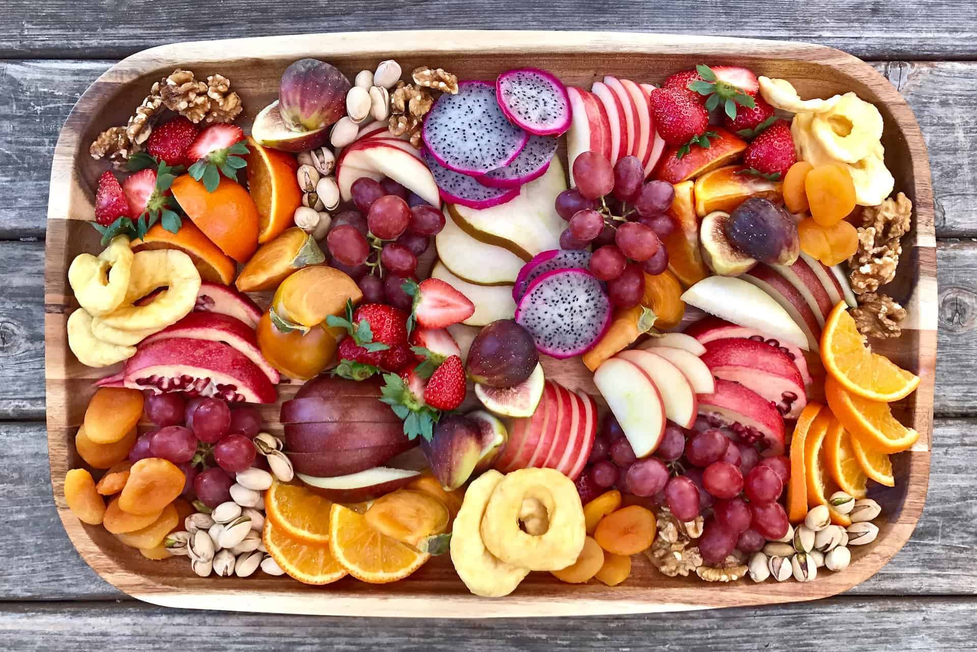 Assorted fruit and snacks on a board