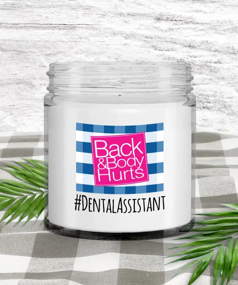 White candle in a jar that says Back & Body hurts #DentalAssistant 
