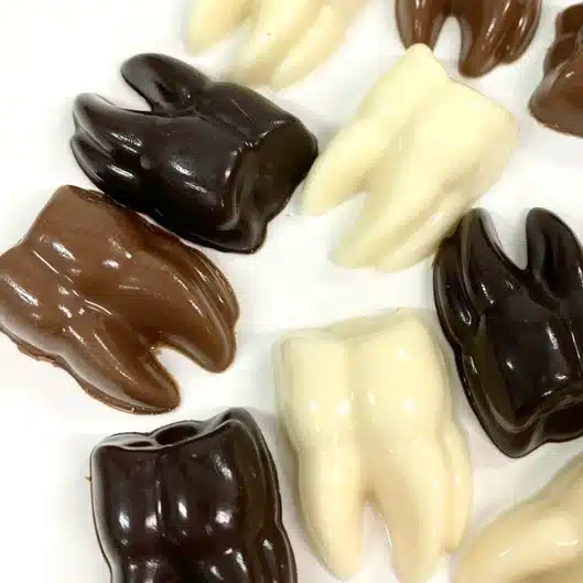 milk chocolate, dark chocolate, and white chocolate shaped teeth. 