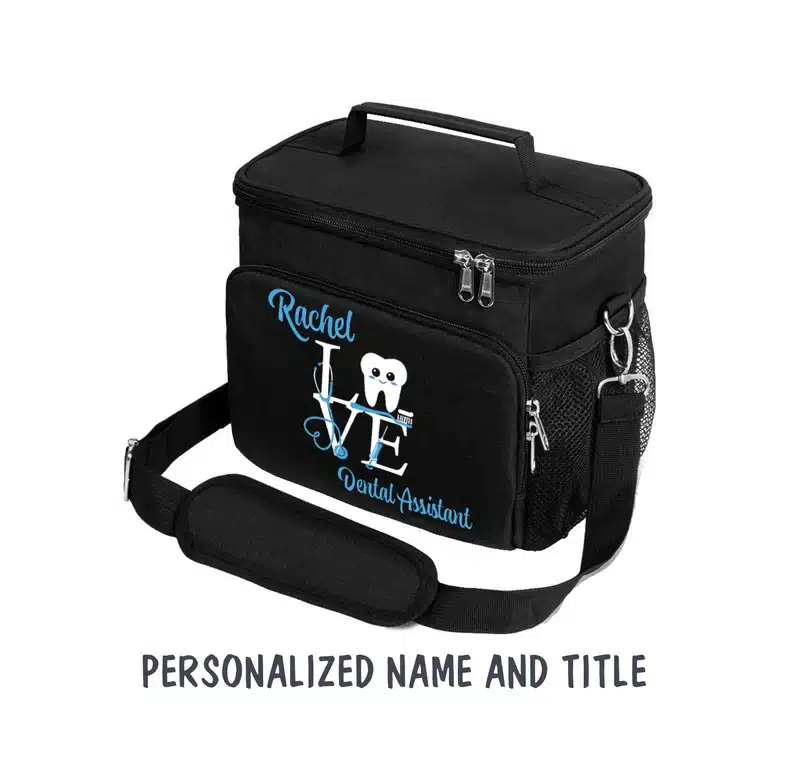 Black lunch bag with light blue font that says Rachel and Dental Assistant. 
