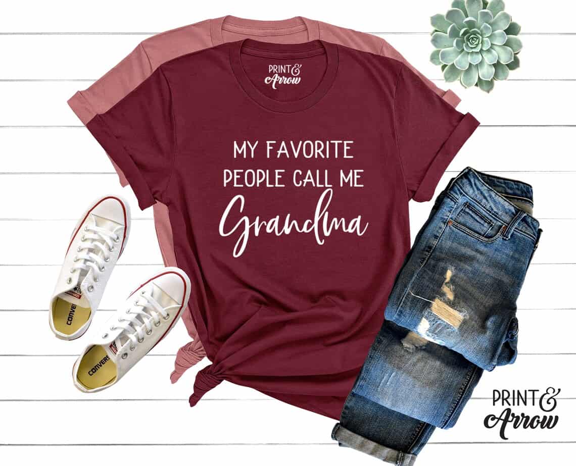 Mother’s Day Gifts for Grandmothers: above view of a wine colored t-shirt with white font that says "my favorite people call me grandma" with jeans and white shoes beside the shirt.