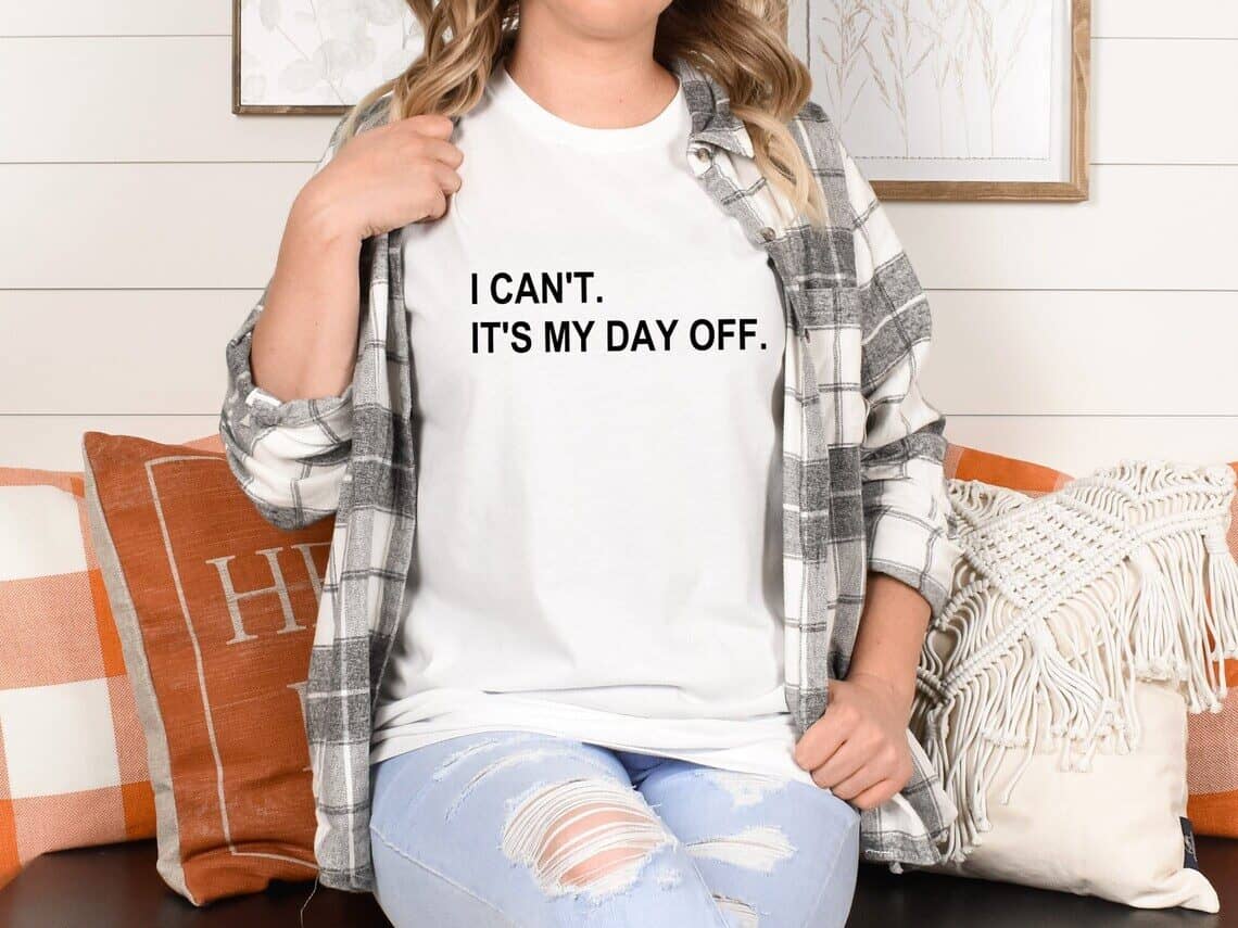 Woman wearing a white t-shirt that says "I can't. It's my day off".