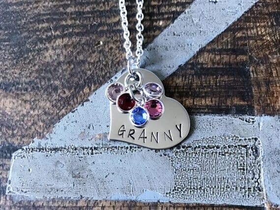Mother’s Day Gifts for Granny: Silver necklace with a hart charm that says granny with five different birthstone charms hanging. 