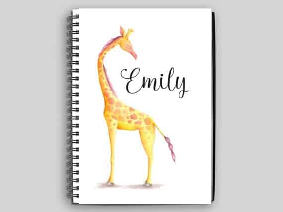 This notebook is a perfect gift ideas for giraffe lovers. White notebook with the name Emily on it and a cartoon Giraffe.