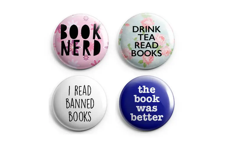 Four round buttons, each with funny book sayings. 