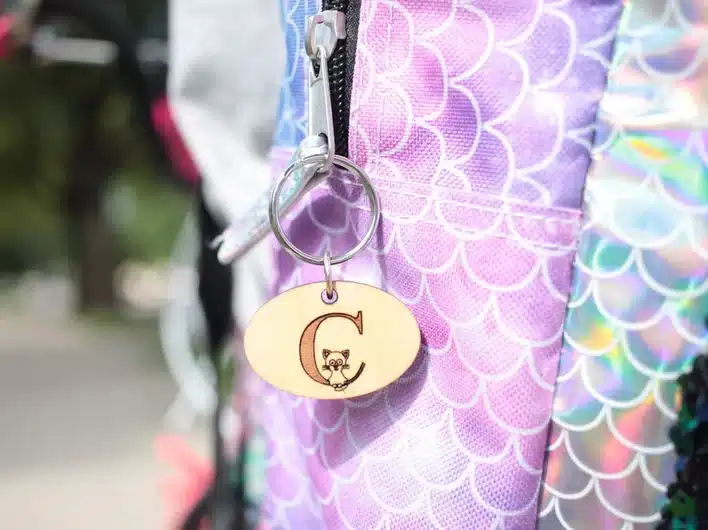 Close up of a mermaid themed bag with a personalized zipper pull. 