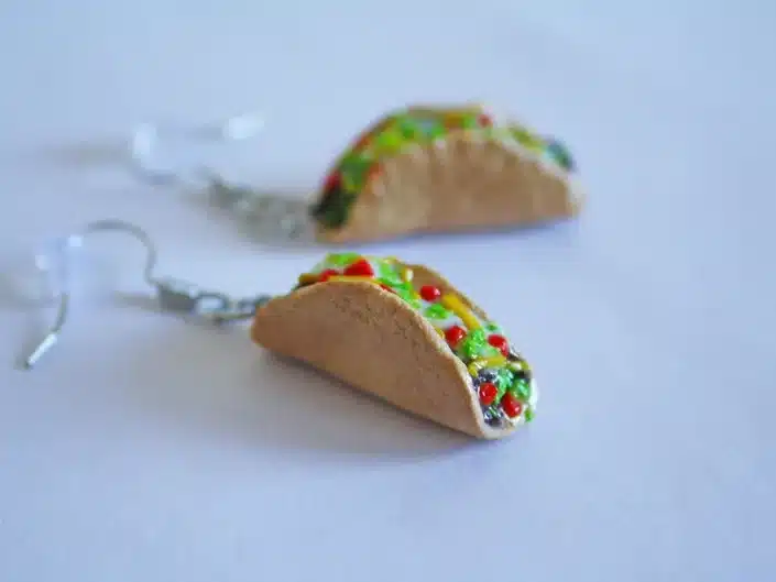Silver earrings with little tacos on the end. 