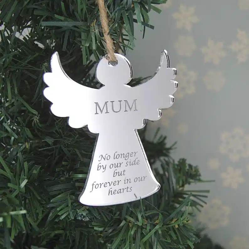 Silver angel shaped ornament that says MUM No longer by our side but forever in our hearts. 