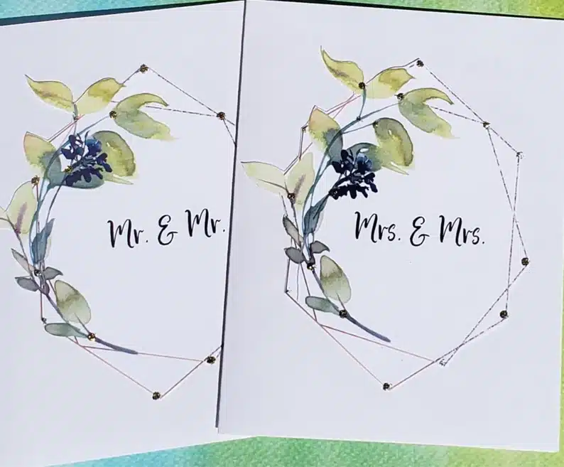 White cards with water colored green and flowers with Mr. & Mr. on one and Mrs. & Mrs. on the other. 