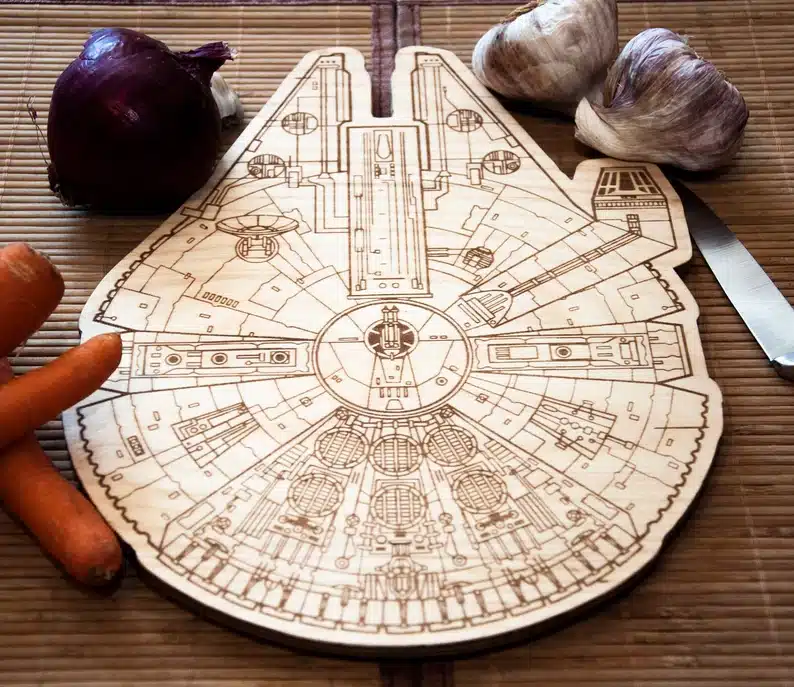 Wooden cutting board cut out to look like the millennium falcon. 