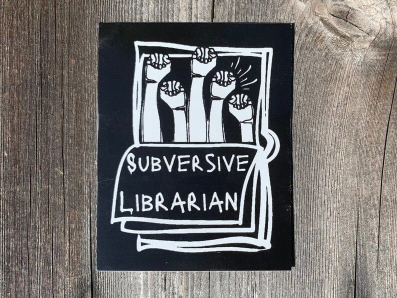 librarian funny sticker gift idea, black sticker with white font that says "subversive librarian" with arms in the air above.