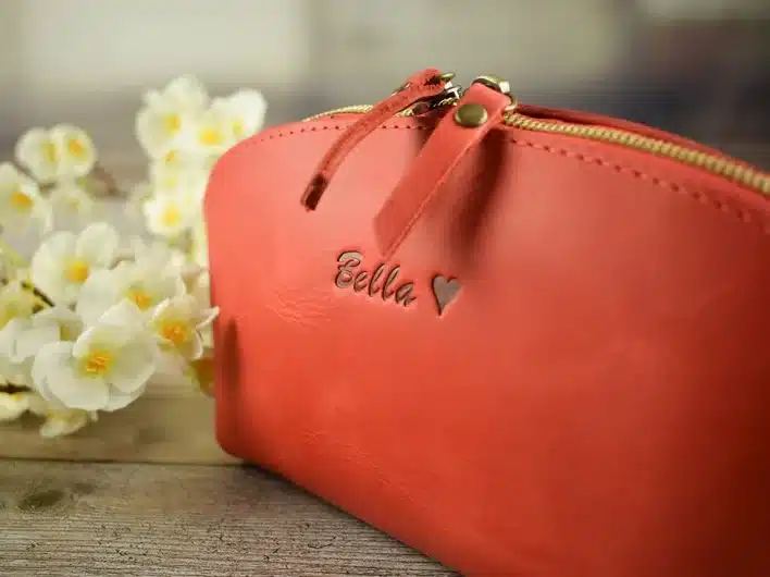 Mother’s Day Gifts for Granny: Orange/brown leather makeup bag that can be personalized. 