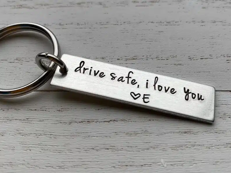 Mother's Day Gifts for My Boyfriend's Mom: silver keychain with rectangle attachment with black engraved font that says 