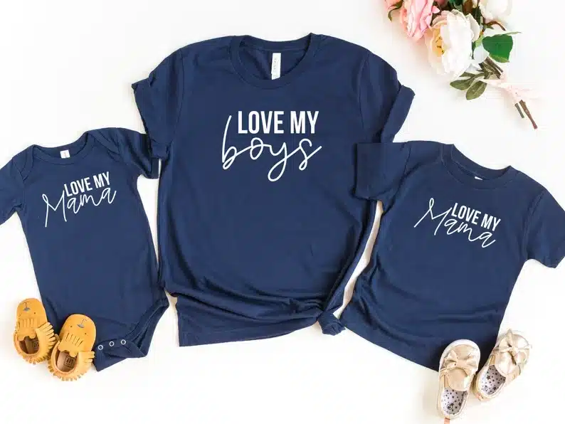 Navy blue t-shirt with white font that says "Love my boys" with a blue onesie beside it that says "love my mama" and other side it says Love my mama. 