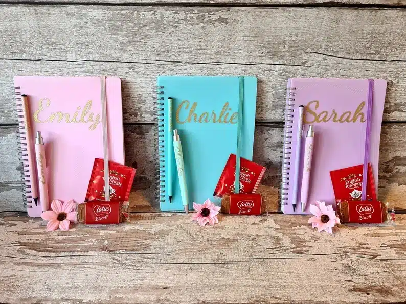 Three personalized stationary set, light pink, blue, and lavender colored. 