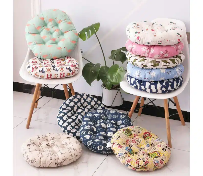 Various round chair pads each different colored and patterns. 