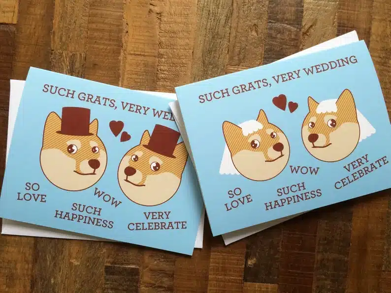 Two cards shown, both light blue with dogs on them, one with two dogs with grooms hats and the other two dogs with veils on their heads. 