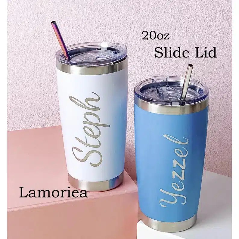 Two personalized tumblers with a straw, one light mint color with silver font that says Steph and one bright blue with silver font that says Yezzel. 