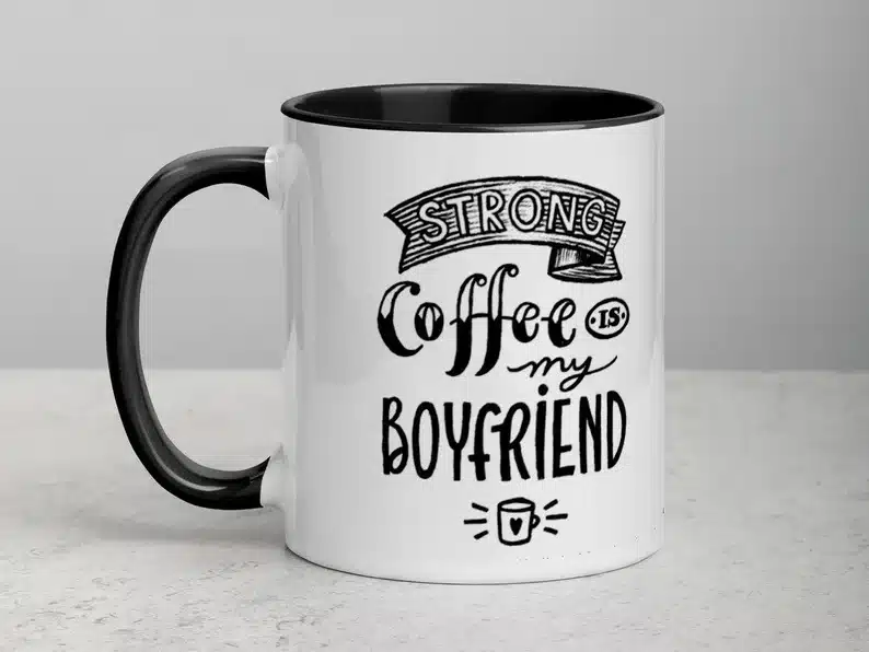 White coffee mug with a black handle and black font that says 