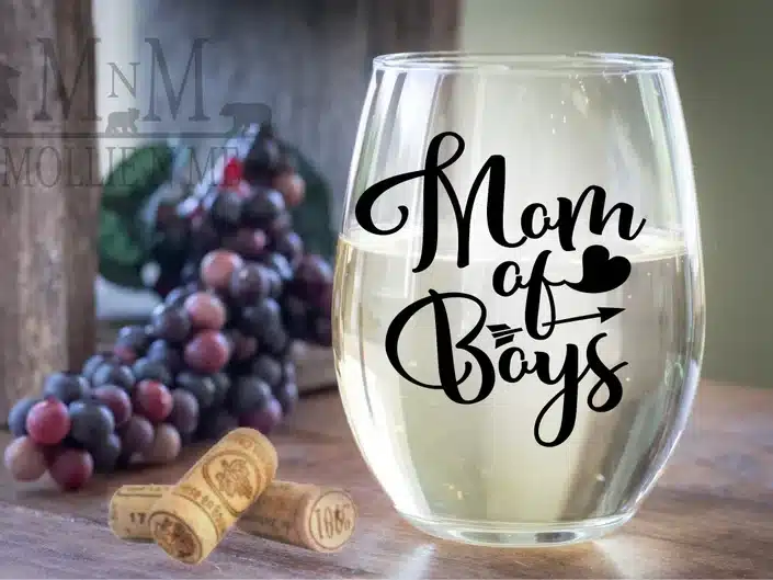 Clear stemless glass wine glass with black font that says Mom of boys. 
