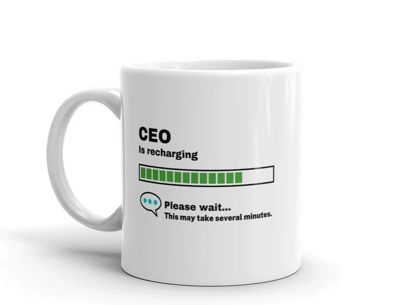 White coffee mug with black font that says CEO is recharging. with a green loading=