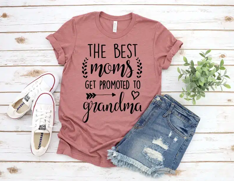 Dusty rose t-shirt with black font that says "The best moms get promoted to Grandma" 