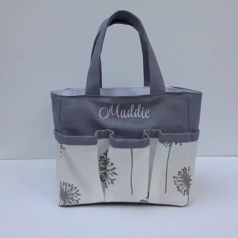 Personalized shower caddy, grey top and tan bottom tote bag with dandelions on it. 