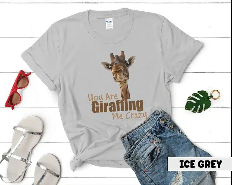 White t-shirt that says you are giraffing me crazy with a giraffe on it. 
