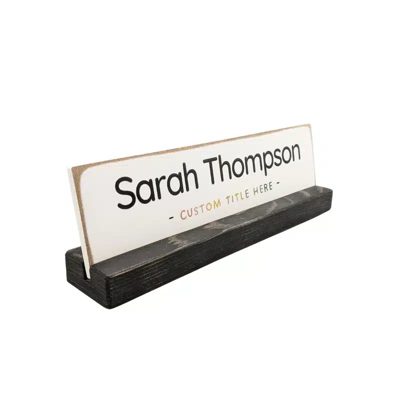 Custom name plate, white with black font that says Sarah Thompson and custom title here. 