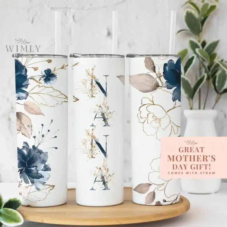 Three tall white tumblers with blue flowers and NANA on it. 