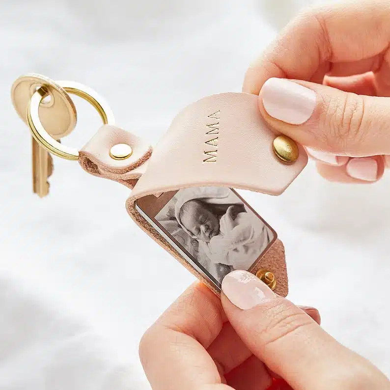 Leather golden keyring, leather says mama that opens to show a baby photo. 