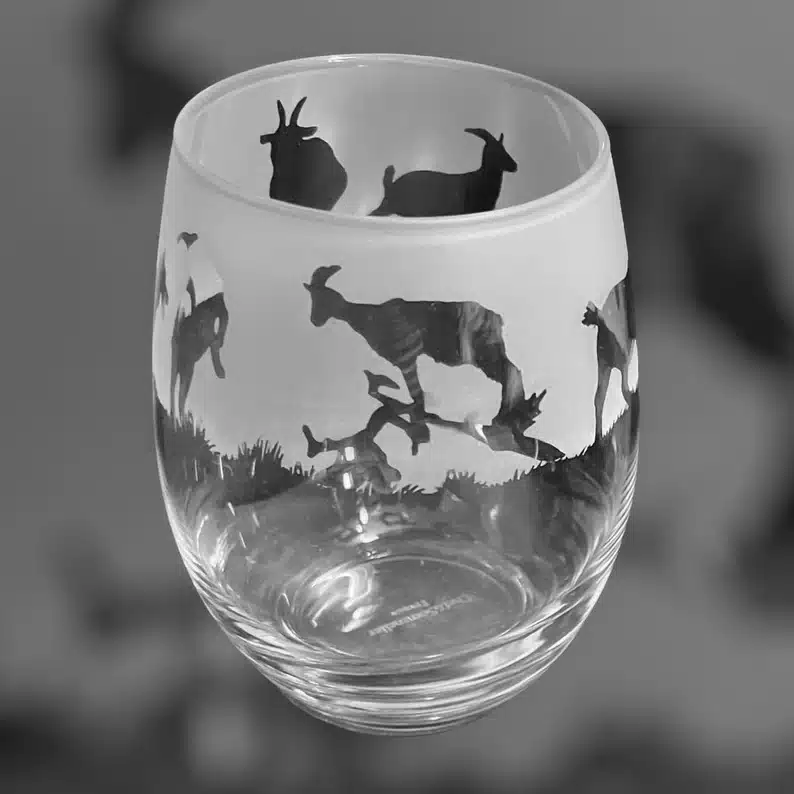 Stemless wine glass, half frosted with goat outlines on it. 